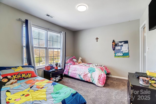 carpeted bedroom featuring baseboards and visible vents