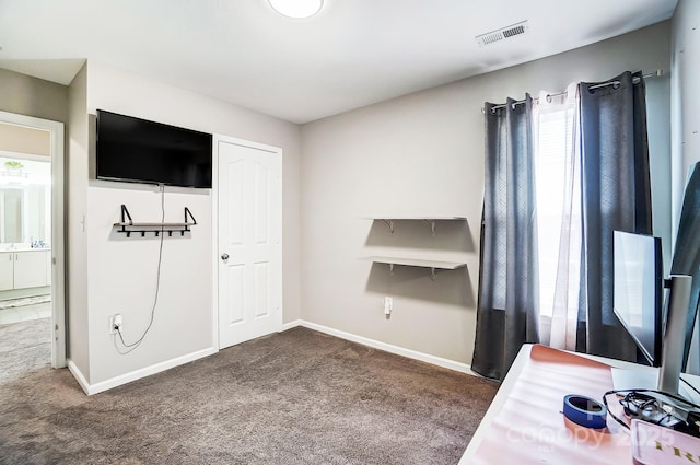 interior space with carpet floors, a healthy amount of sunlight, baseboards, and visible vents