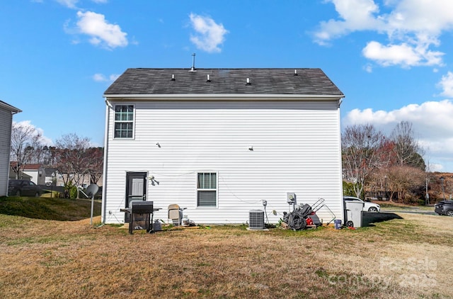 rear view of house featuring a yard and cooling unit