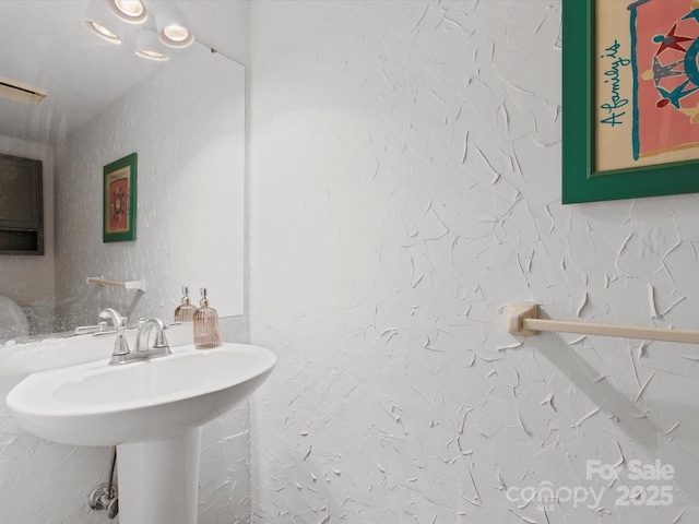 bathroom featuring a textured wall