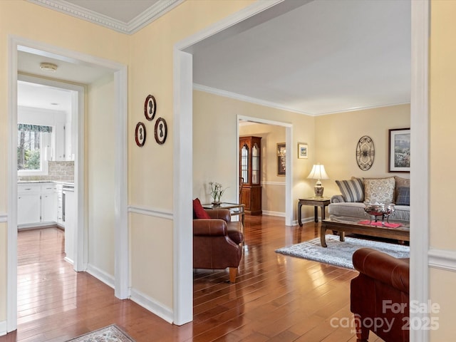 interior space featuring baseboards, crown molding, and hardwood / wood-style flooring