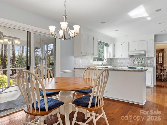 dining room with a notable chandelier and wood finished floors