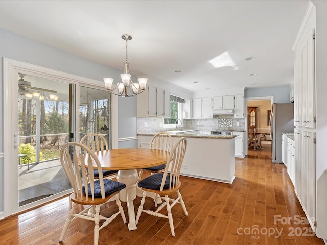 dining area with an inviting chandelier and light wood-style flooring