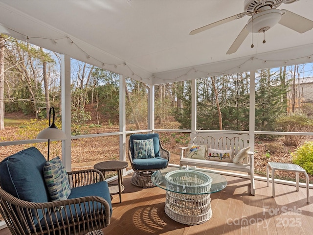 sunroom / solarium featuring ceiling fan