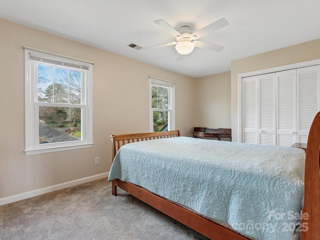 bedroom featuring visible vents, baseboards, carpet flooring, a closet, and a ceiling fan