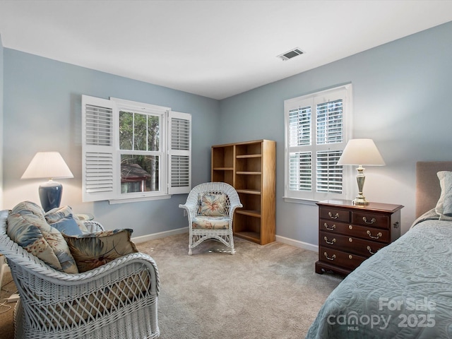 carpeted bedroom with baseboards and visible vents