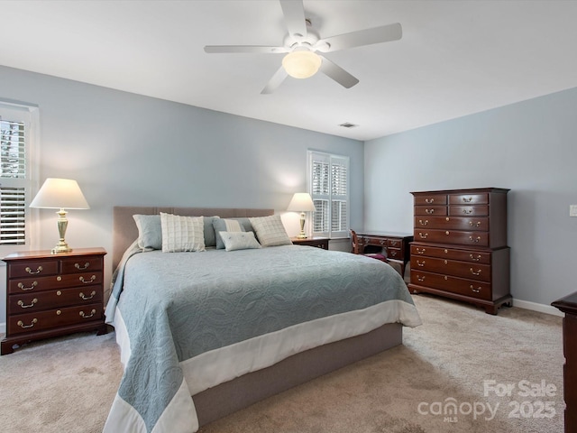 carpeted bedroom featuring baseboards and ceiling fan