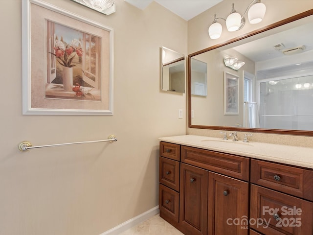 bathroom featuring tile patterned floors, baseboards, and vanity