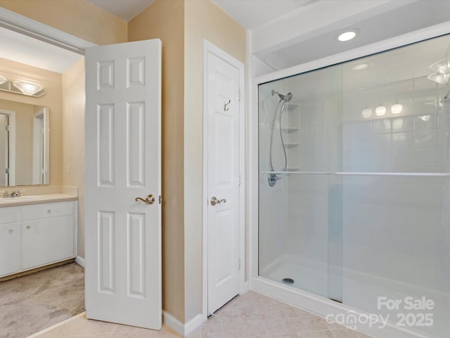 full bathroom with vanity, baseboards, and a stall shower