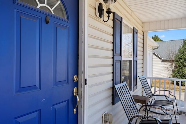 view of exterior entry featuring a porch