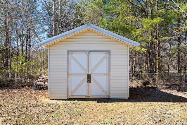 view of shed featuring fence