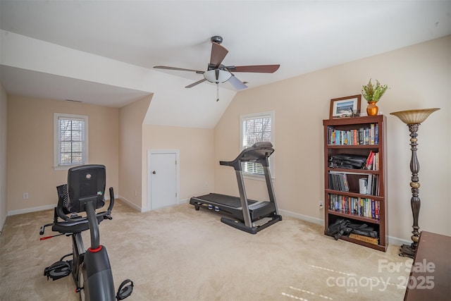 workout area featuring vaulted ceiling, carpet, baseboards, and a healthy amount of sunlight