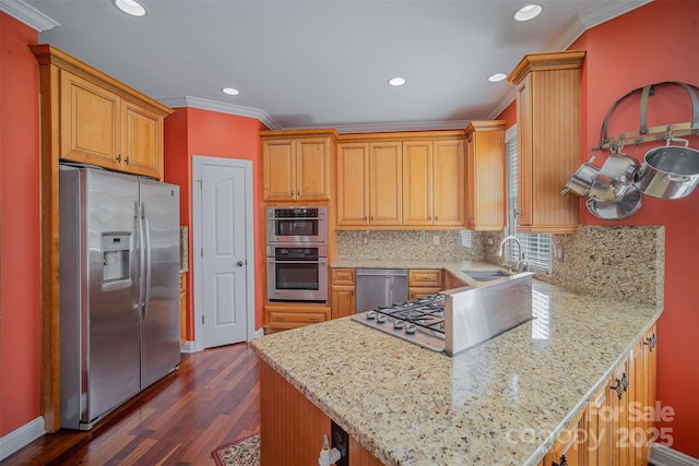 kitchen featuring stainless steel appliances, recessed lighting, decorative backsplash, ornamental molding, and a sink