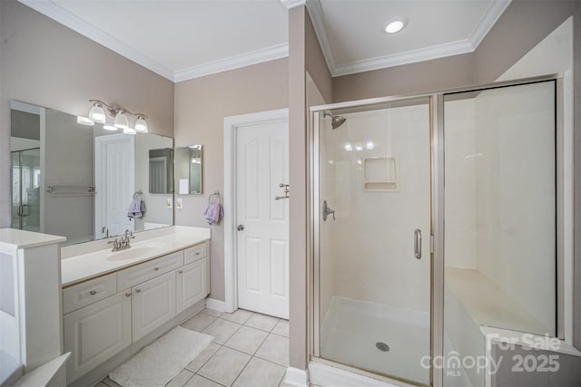 bathroom with a stall shower, vanity, and crown molding