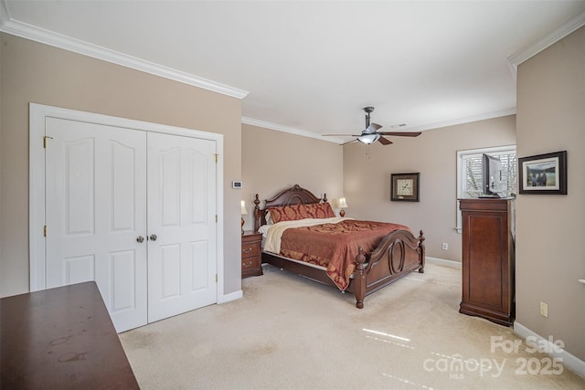 bedroom featuring baseboards, a closet, light colored carpet, and crown molding