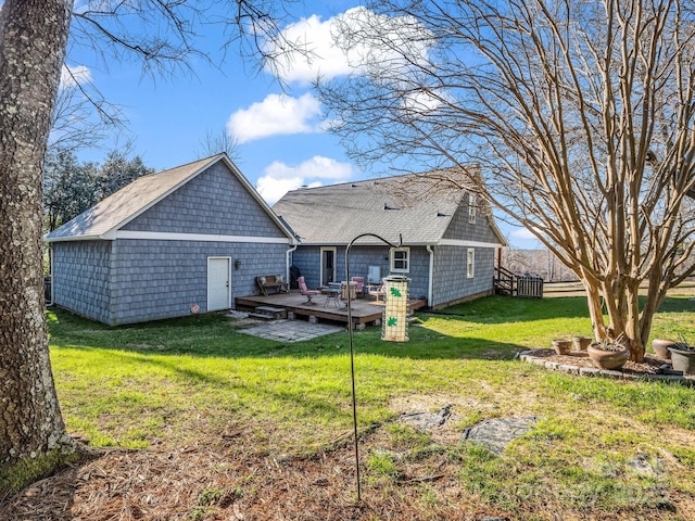 back of property with a deck and a yard