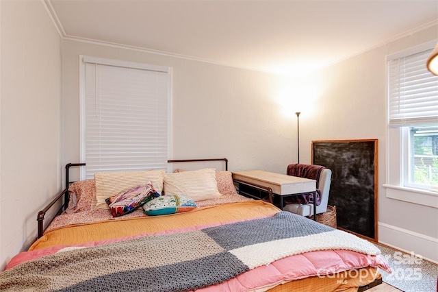 bedroom with ornamental molding and baseboards