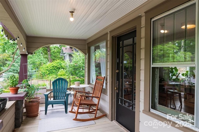 wooden terrace with a porch