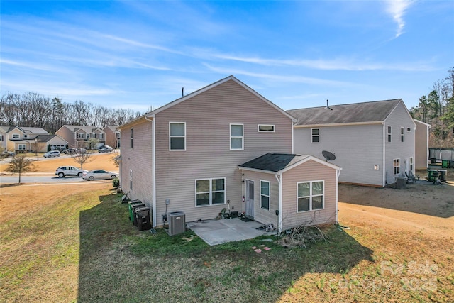 back of property with a patio area, a yard, and central air condition unit