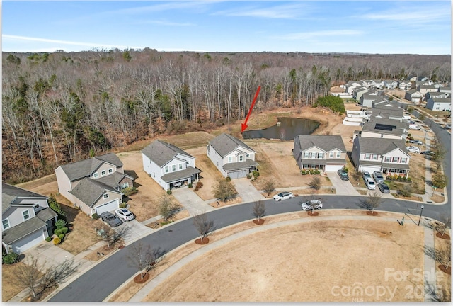 aerial view with a residential view and a view of trees