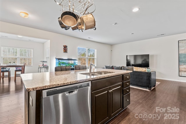 kitchen featuring dark wood-style flooring, a sink, open floor plan, dishwasher, and a center island with sink