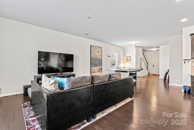 living area with baseboards and hardwood / wood-style flooring