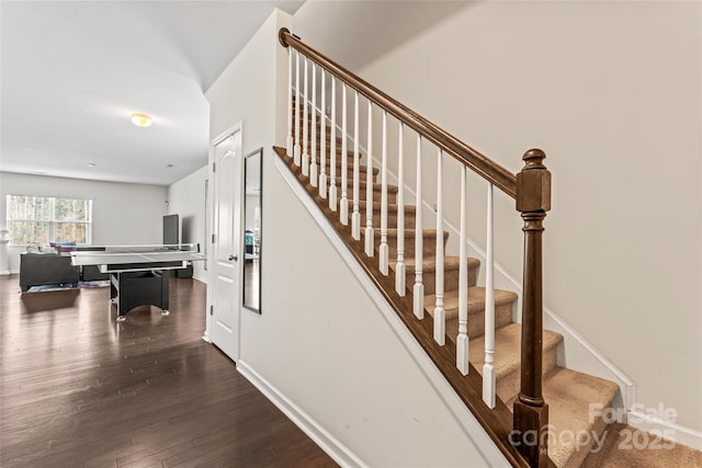 stairway featuring baseboards and hardwood / wood-style floors