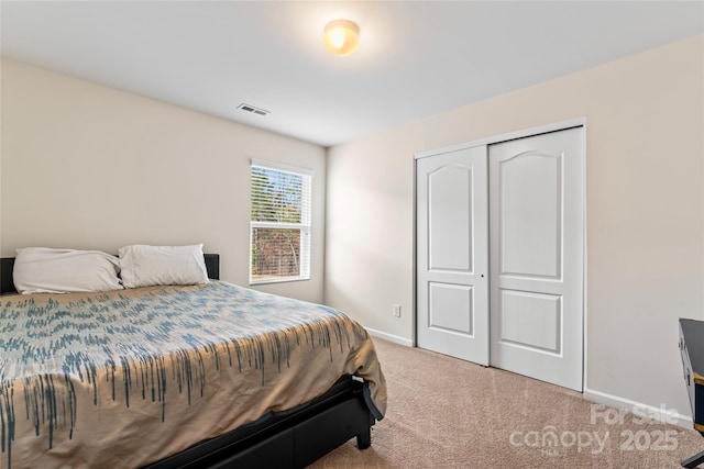 bedroom featuring carpet floors, a closet, visible vents, and baseboards