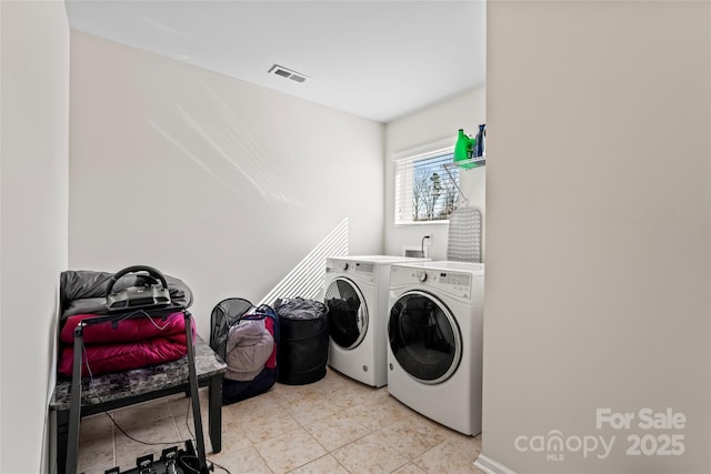 laundry area featuring laundry area, washing machine and dryer, and visible vents