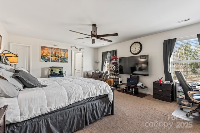 bedroom with ceiling fan, carpet floors, visible vents, and baseboards