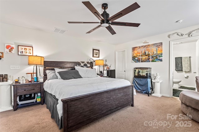 bedroom featuring light colored carpet, visible vents, ceiling fan, ensuite bath, and baseboards