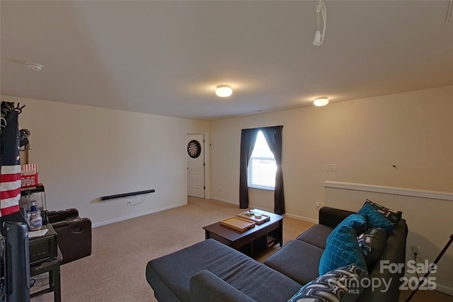 carpeted living room featuring baseboards