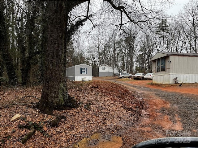 view of street with gravel driveway