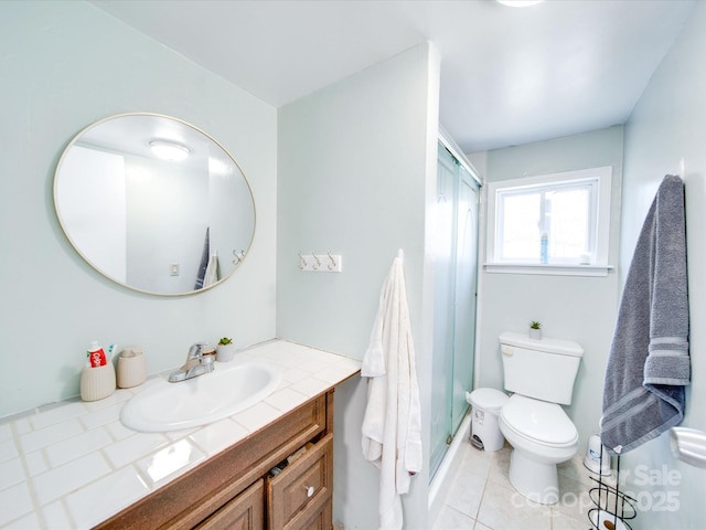 full bath featuring a shower with door, vanity, toilet, and tile patterned floors