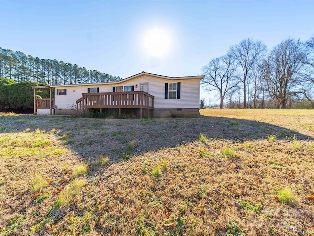 rear view of property with crawl space and a deck