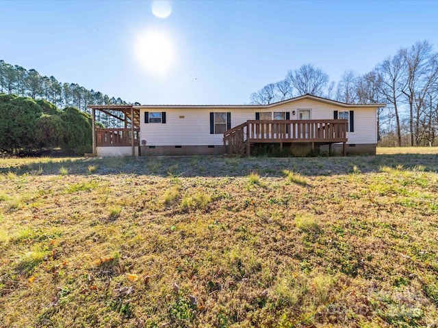 rear view of house with a wooden deck and crawl space