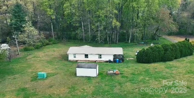 birds eye view of property with a forest view