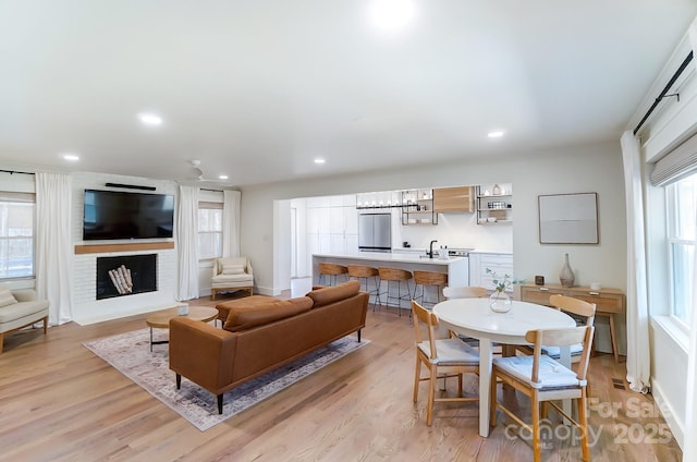 living area featuring recessed lighting, light wood-style floors, and a healthy amount of sunlight