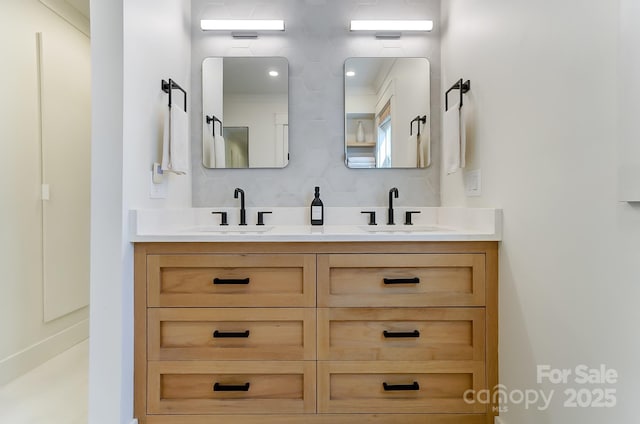 full bathroom with double vanity and a sink