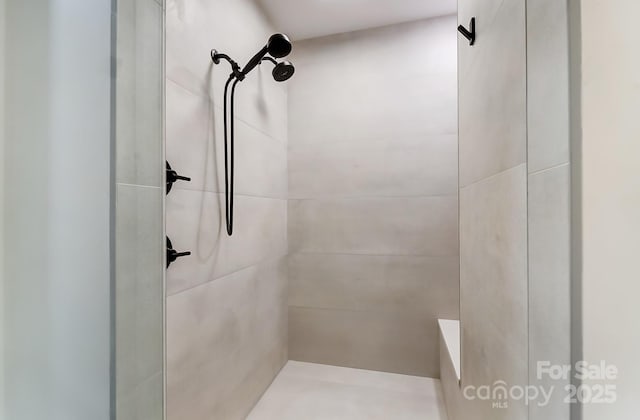 full bath with a tile shower