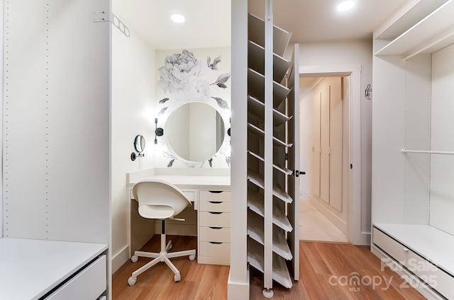 bathroom featuring vanity, recessed lighting, and wood finished floors