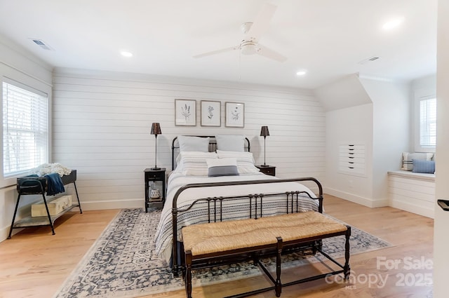 bedroom featuring visible vents, baseboards, and light wood finished floors