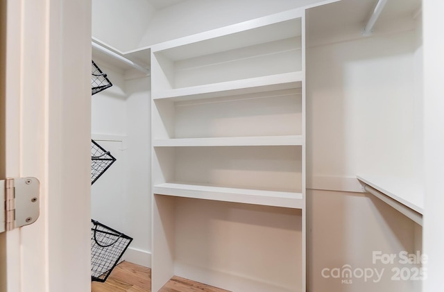 spacious closet with wood finished floors