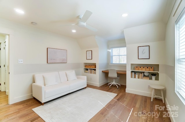 living room with a ceiling fan, recessed lighting, and wood finished floors