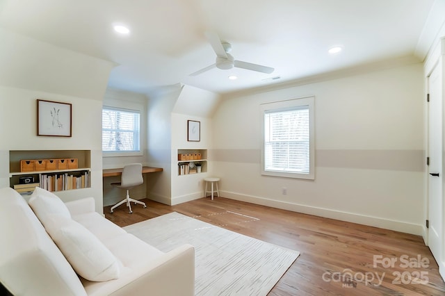 living room with recessed lighting, ornamental molding, baseboards, and wood finished floors