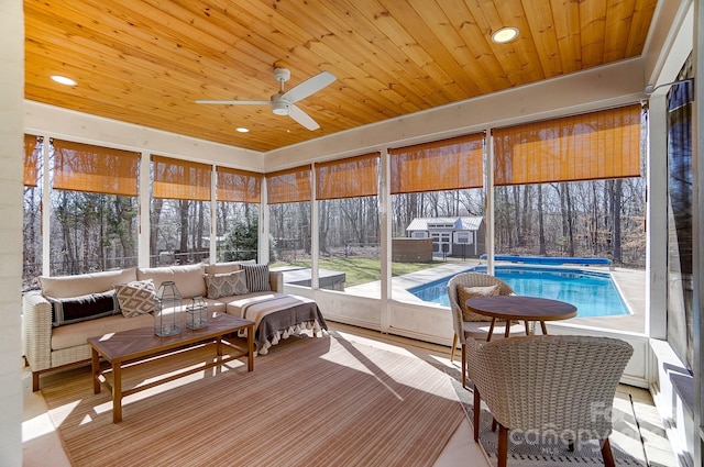 sunroom with wooden ceiling and a ceiling fan