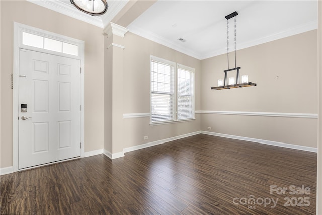 entryway featuring ornate columns, baseboards, wood finished floors, and crown molding