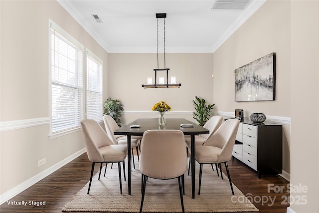 dining space featuring baseboards, visible vents, dark wood-type flooring, and crown molding