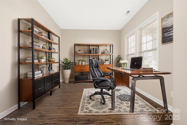 office with dark wood-style floors, visible vents, and baseboards