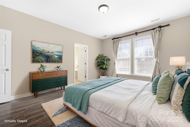 bedroom featuring baseboards, dark wood-style flooring, and ensuite bathroom